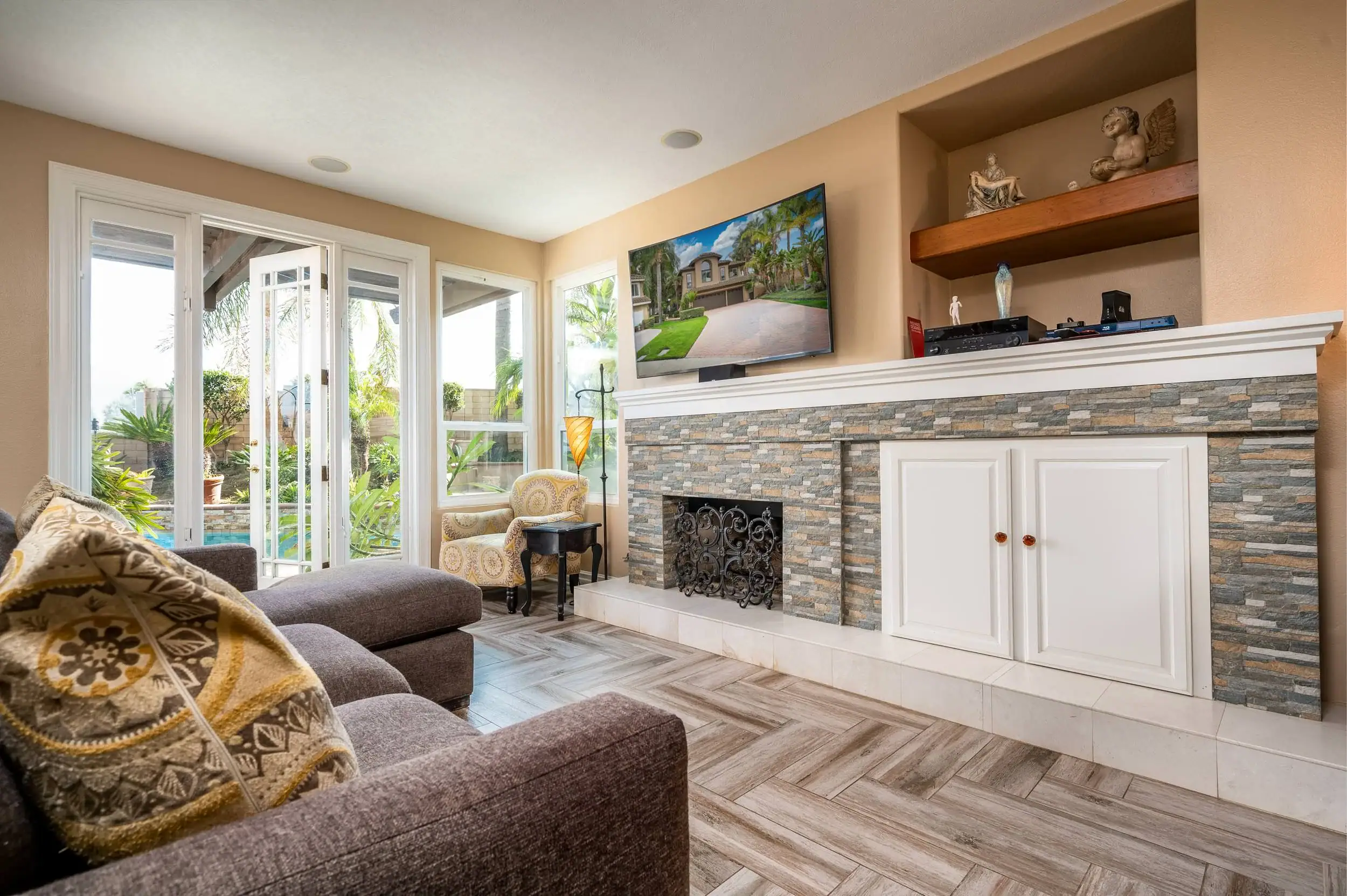 Bright, inviting interior showcasing a cozy seating area, large windows, and a scenic outdoor view, perfect for real estate listing photos.