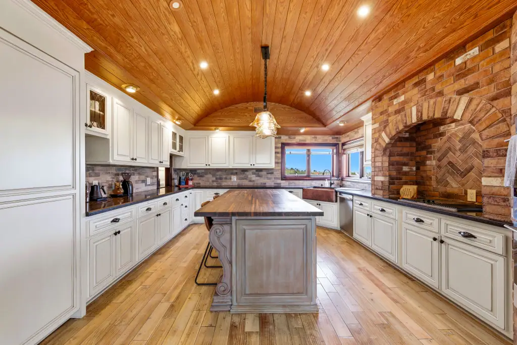 Photography of a Kitchen with wood floors and ceilings. <mark class=